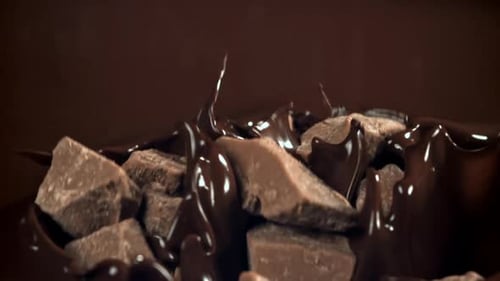 Pieces of Chocolate Fall Into the Melted Chocolate Filmed on a Highspeed Camera at 1000 Fps