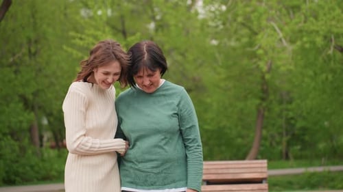 Girls Strolling Through Lush Park Ladies Walking Arm In Arm Smiling Happily Two Women Share Joyful