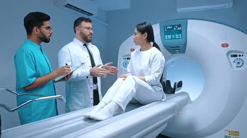 Doctors Consult with Patient Before CT Scan