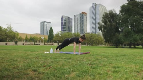 Forward moving shot of Caucasian woman doing yoga Chaturanga ...