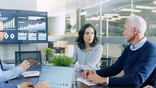 Business Team Meeting Discussing Data in Modern Office