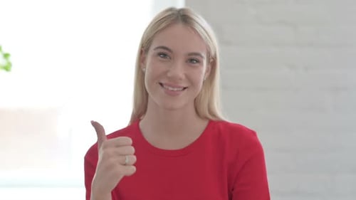 Young Woman Gives Thumbs Up Approval