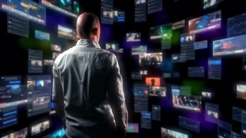 Man Stands Amongst Floating Screens with Data and Media