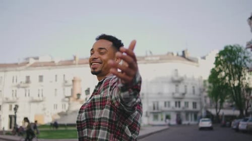 Portrait of a Young African American Man on the Street A Young Guy Stands on the Street and Camera