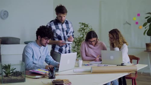 Group Of Young People Working Together In An Office.
