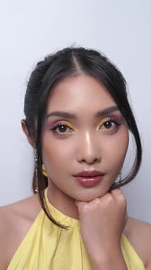 Woman With Yellow Eyeshadow and Gold Earrings Posing Woman With Yellow Eyeshadow and Gold Earrings Posing