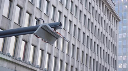 Modern Security Camera Surveillance Mounted on Exterior of Urban Office Building