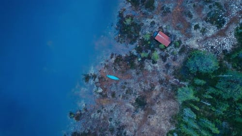 Above View Of A Cabin By The Forest Lake. Aerial Shot