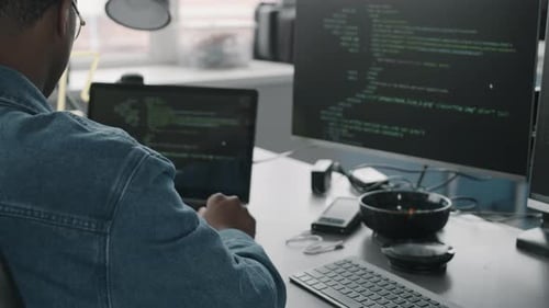 Black Male System Administrator Coding in Office