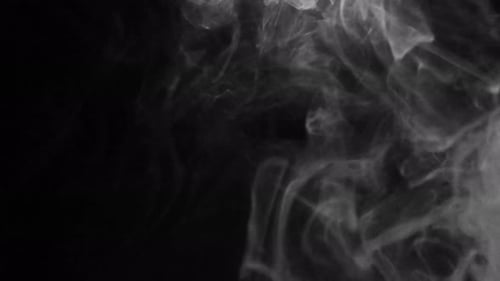 Abstract Smoke Slowly Drifting on Black Background