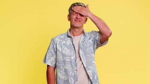 Man with Headache Presses Fingers to Temples