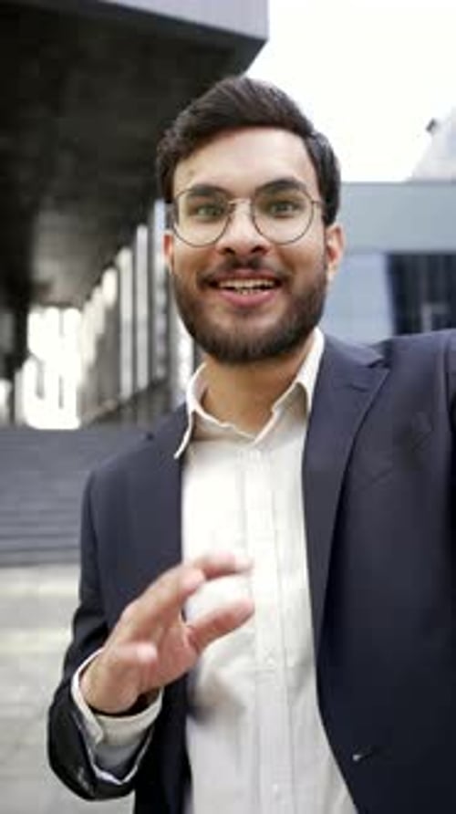Cheerful Young Man Talking and Gesturing Outdoors