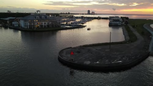 Hotel Lights Illuminating By The Port In Louisiana Near An Old Lighthouse- aerial shot