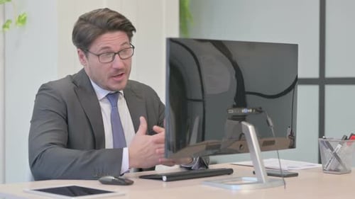 Man in Suit Talking on Computer Video Call