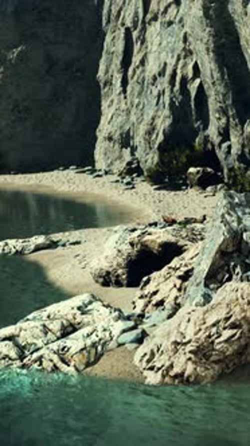 Small Sand Ocean Beach Near Rocky Cliff