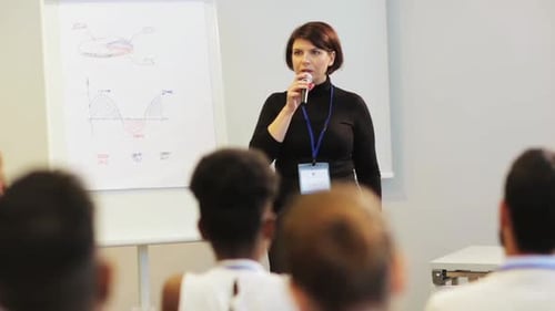 Professional Woman Presenting Charts at a Corporate Conference