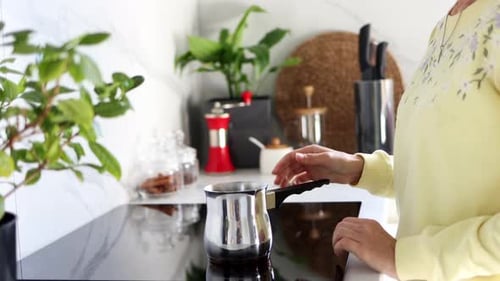 Woman Prepares Coffee in Modern Kitchen