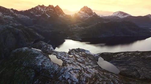 Golden Hour in Norway Aerial Perspective of SnowCapped Mountains and Islands at Sunset Under Dark