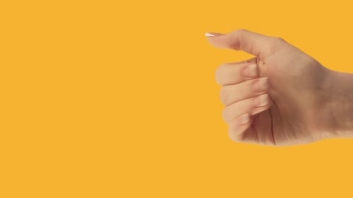 Hand Gesture for a Handshake on Yellow Background