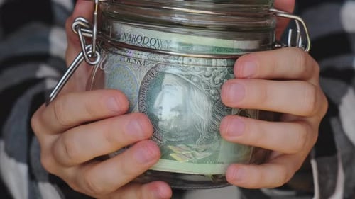 Polish Zloty Banknote Saving Money in Glass Jar