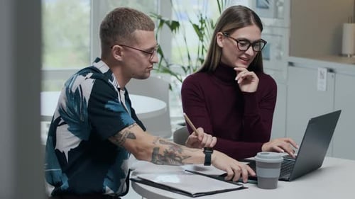 Young Adults Collaborating in Workplace Environment
