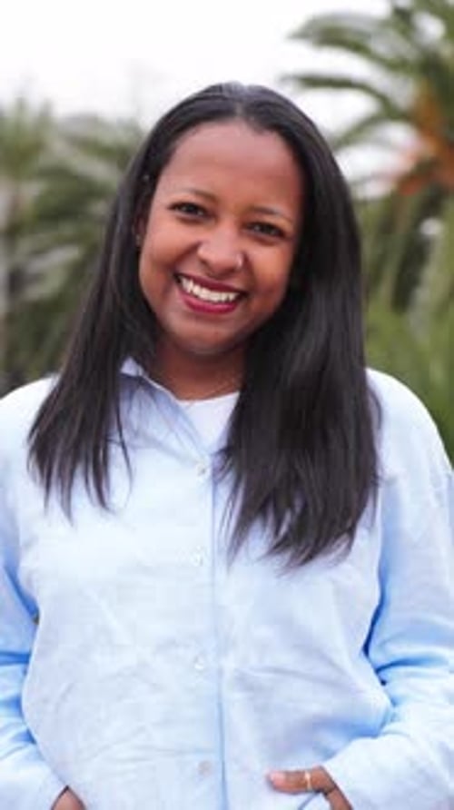 Smiling Woman with Black Hair in Urban Setting