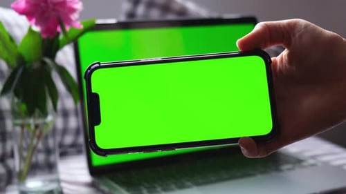 Close Up Woman Using Smartphone Green Screen with Laptop Computer Chromakey