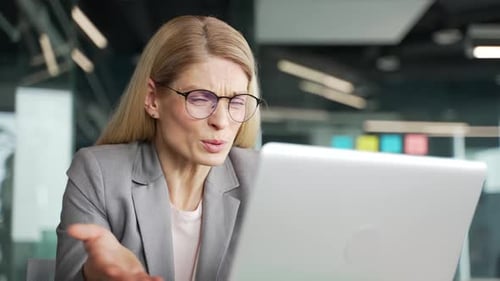 Annoyed Business Woman on Laptop Having a Video Call