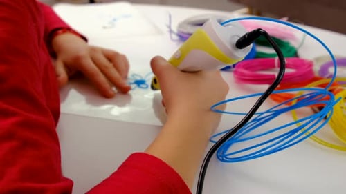 Child Creating Flower With 3D Printing Pen