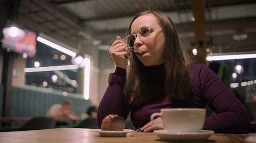 Woman Enjoying Chocolate Cake in Restaurant