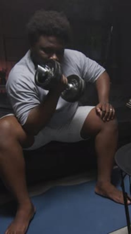 Man Does Bicep Curls at Home