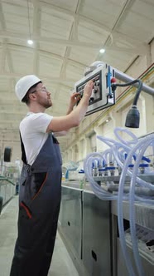 Worker On Factory Analyzes The Production Process And Programming Industrial CNC Machine Tool