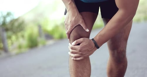 Adult with Painful Knee Injury Outdoors