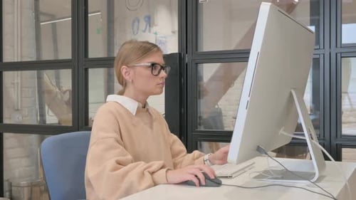 Young Woman Working on Computer in Modern Office