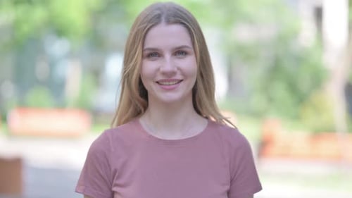 Young Woman Talking and Smiling at the Camera