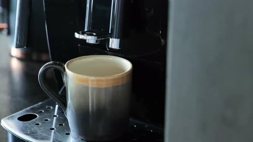 Fresh Espresso Being Poured into a Stylish Mug