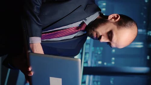 Young Man Working Late at Night on Laptop