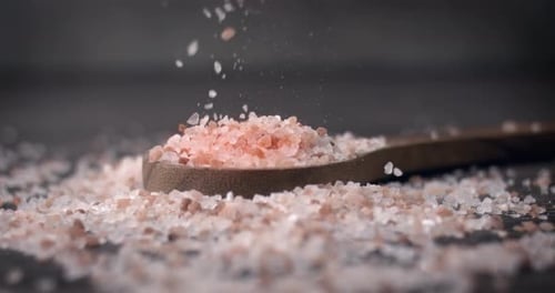 Pouring Pink Himalayan Salt onto a Spoon