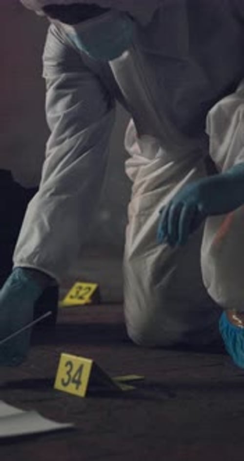 Forensic Investigator Collecting Evidence at a Crime Scene