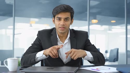 Indian entrepreneur discussing a project with team