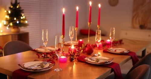 Festive Christmas dinner table setting with candles