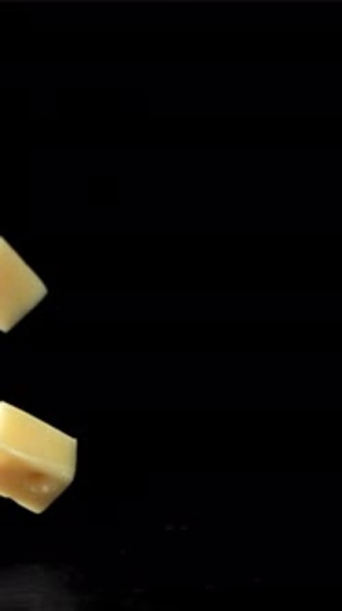 Super Slow Motion Pieces of Cheese on Black Background Filmed on a Highspeed Camera at 1000 Fps