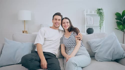 Happy Couple Relaxing Together on Couch at Home
