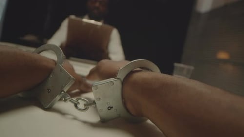 Close Up of Handcuffed Man During Police Interrogation