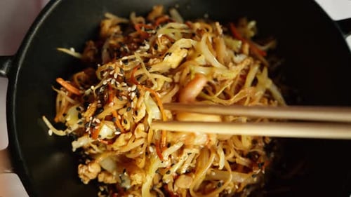 Close up view of wok rice noodles with king prawns and steam served at a traditional japanese restau