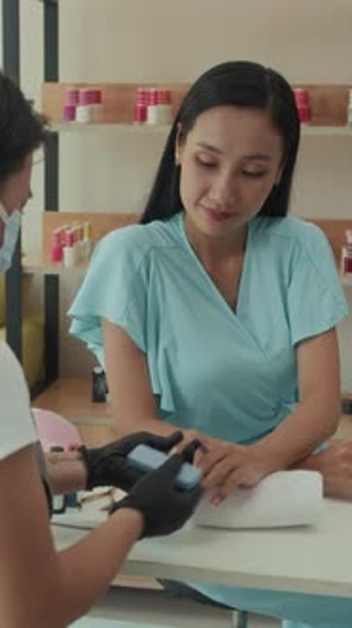 Beauty Studio Specialist Manicuring Nails of Woman