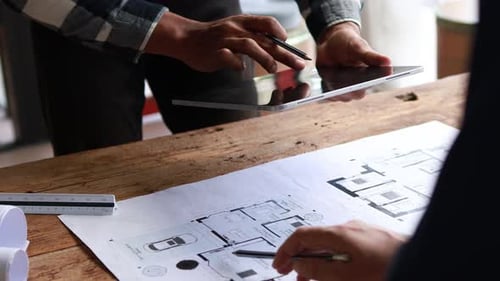 Architect Reviewing Detailed Building Plans For Efficient Project Development