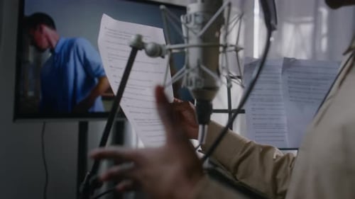 Black Female Voice Actress Recording her Lines for Movie Scene in Studio