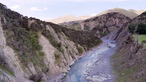 Serene Aerial Journey Over Mountainous River Canyon Landscape