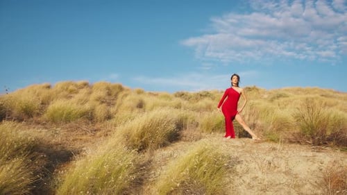 Woman Dressed In Elegant Red Dances In The Hills Of Sicily
